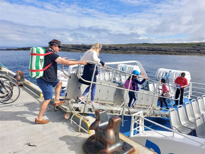 Passengers boarding Aran Islands Express ferry at Doolin Pier with Doolin Ferry Company.