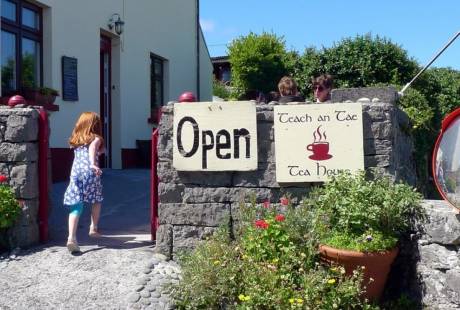 girl running through gate to teach an Tae Cafe on Inisheer